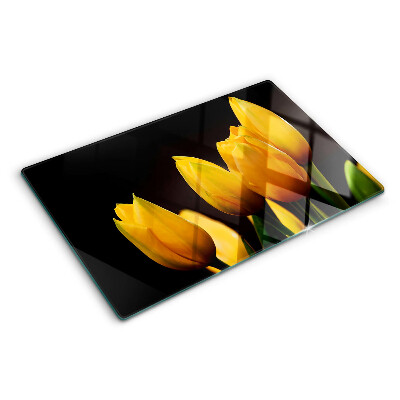 Tabla de cortar de cristal Tulipanes amarillos sobre fondo negro