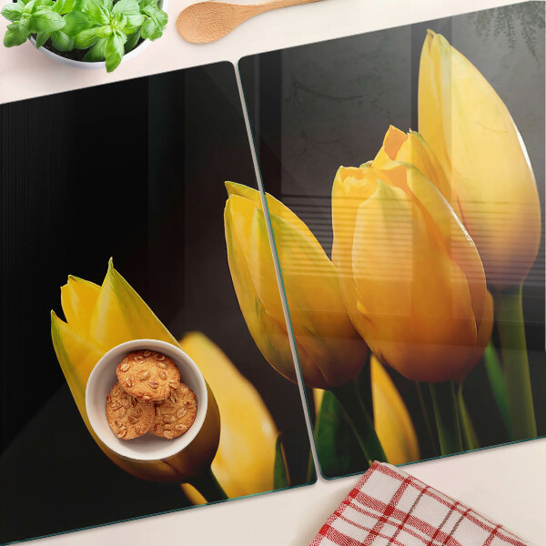 Tabla de cortar de cristal Tulipanes amarillos sobre fondo negro