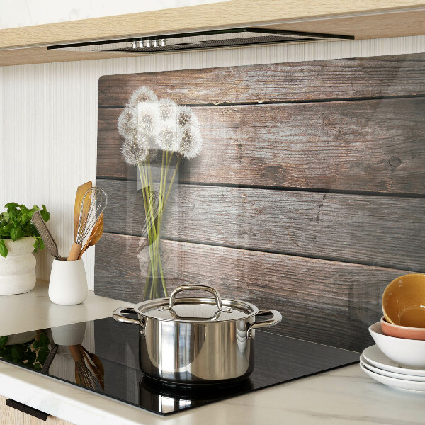 Tabla de cortar de cristal Flores de diente de león sobre un fondo de madera