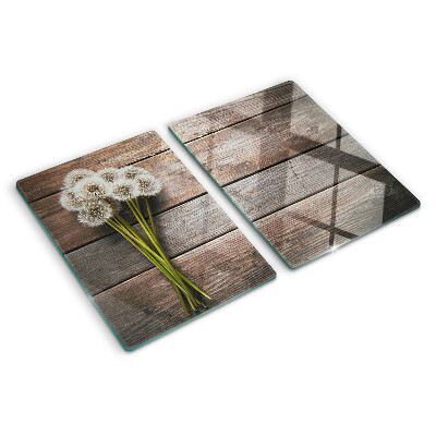 Tabla de cortar de cristal Flores de diente de león sobre un fondo de madera