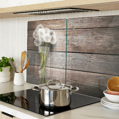 Tabla de cortar de cristal Flores de diente de león sobre un fondo de madera