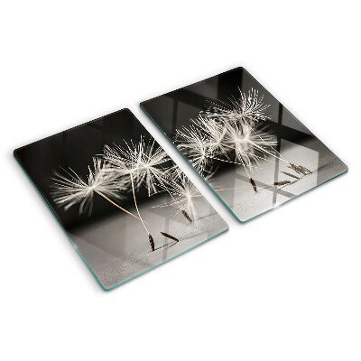 Tabla de cortar Dientes de león esponjosos sobre un fondo monocromático