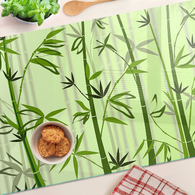 Tabla de cortar de cristal Bambú sobre un fondo verde