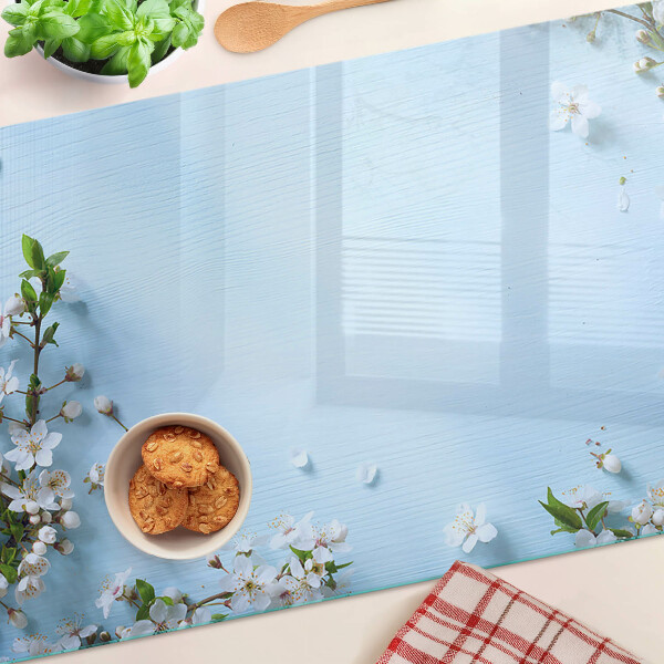 Tabla de cortar de cristal Patrón floral sobre fondo azul.