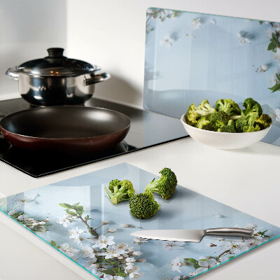 Tabla de cortar de cristal Patrón floral sobre fondo azul.