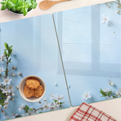 Tabla de cortar de cristal Patrón floral sobre fondo azul.