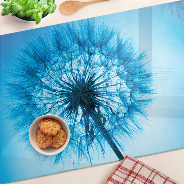 Tabla de cortar de cristal Diente de león sobre fondo azul