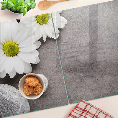 Tabla de cortar Flores y piedras al fondo.