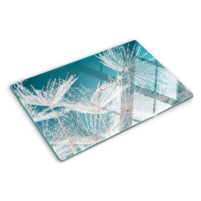 Tabla de cocina Dientes de león sobre un fondo azul