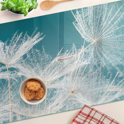 Tabla de cocina Dientes de león sobre un fondo azul