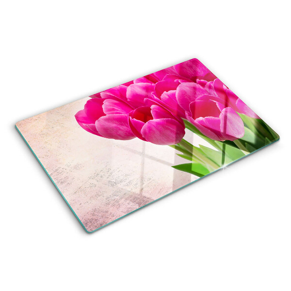 Tabla de cortar de cristal Flores de tulipán sobre un fondo rosa