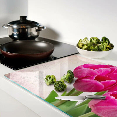Tabla de cortar de cristal Flores de tulipán sobre un fondo rosa