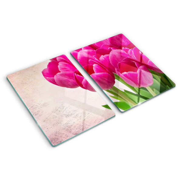 Tabla de cortar de cristal Flores de tulipán sobre un fondo rosa