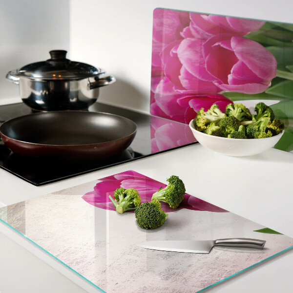 Tabla de cortar de cristal Flores de tulipán sobre un fondo rosa