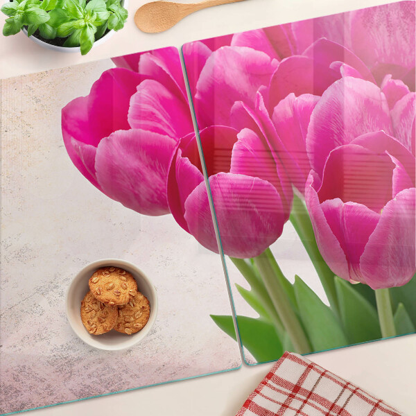 Tabla de cortar de cristal Flores de tulipán sobre un fondo rosa