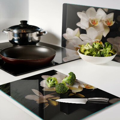 Tabla de cortar de cristal Orquídeas sobre fondo negro