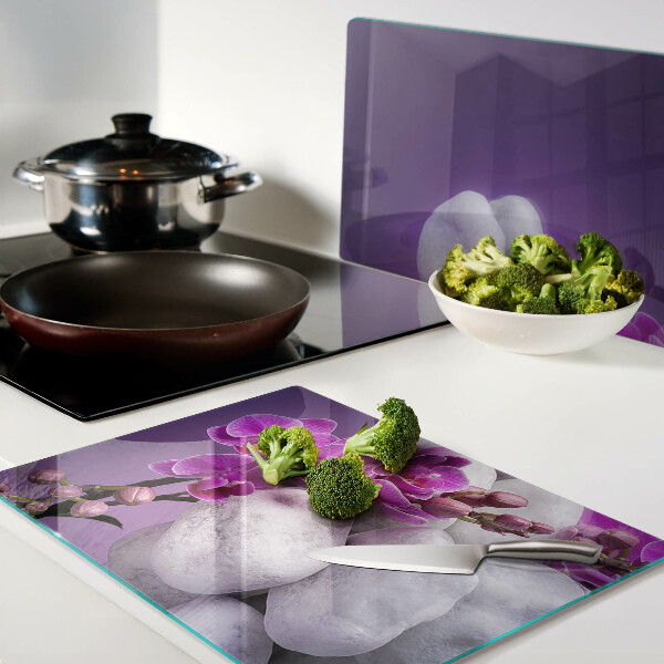 Deska kuchenna szklana Kwiaty orchidei na tle kamieni