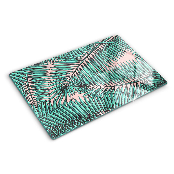 Tabla de cortar Hojas de palma sobre fondo rosa