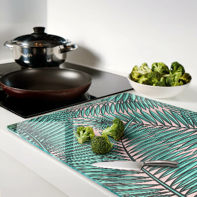 Tabla de cortar Hojas de palma sobre fondo rosa