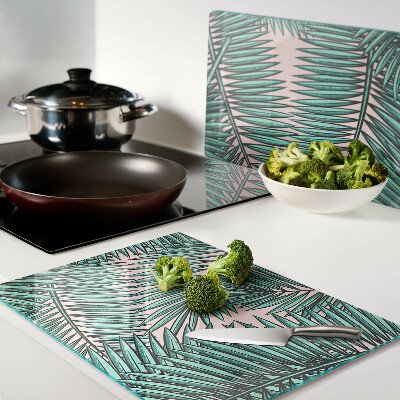 Tabla de cortar Hojas de palma sobre fondo rosa