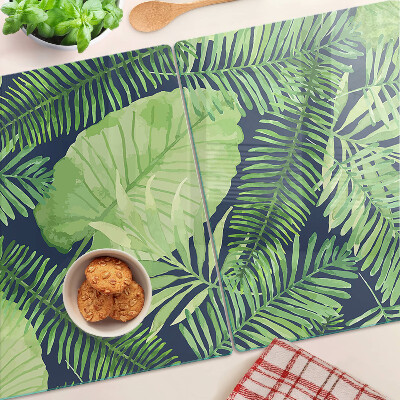 Tabla de cocina Hojas tropicales sobre un fondo oscuro.