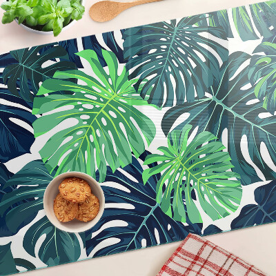Tabla de cocina Hojas de monstera sobre un fondo tropical.