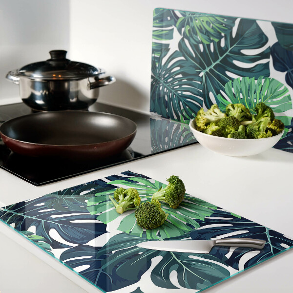 Tabla de cocina Hojas de monstera sobre un fondo tropical.