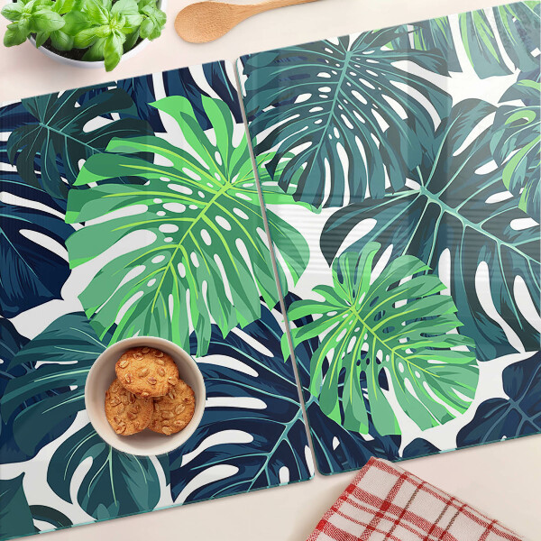 Tabla de cocina Hojas de monstera sobre un fondo tropical.