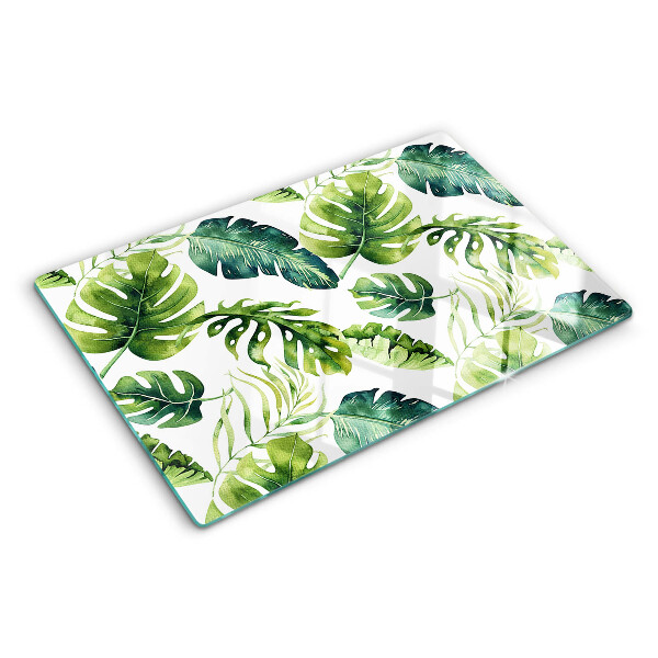 Tabla de cortar de cristal Hojas de monstera en tonos verdes.