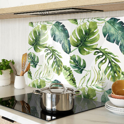 Tabla de cortar de cristal Hojas de monstera en tonos verdes.