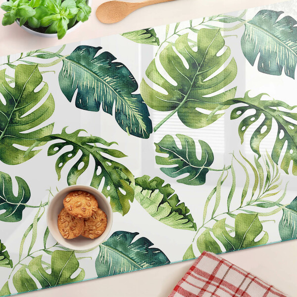 Tabla de cortar de cristal Hojas de monstera en tonos verdes.