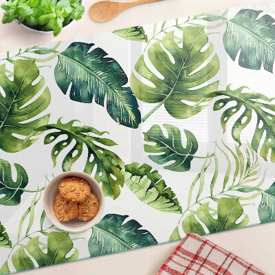 Tabla de cortar de cristal Hojas de monstera en tonos verdes.
