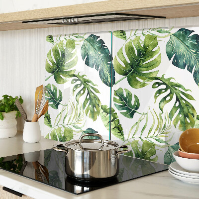 Tabla de cortar de cristal Hojas de monstera en tonos verdes.