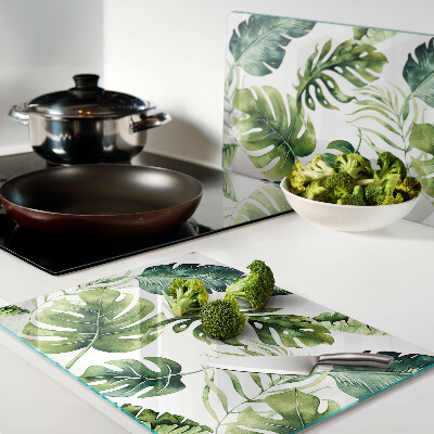 Tabla de cortar de cristal Hojas de monstera en tonos verdes.