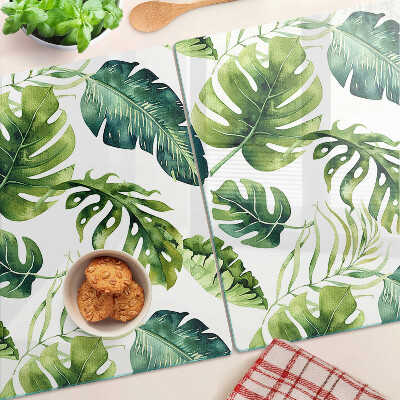 Tabla de cortar de cristal Hojas de monstera en tonos verdes.