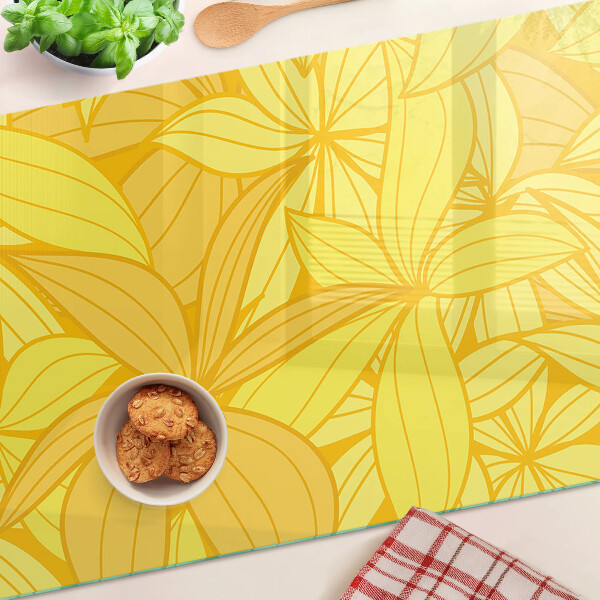 Tabla de cocina Hojas amarillas en estilo tropical.