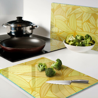 Tabla de cocina Hojas amarillas en estilo tropical.