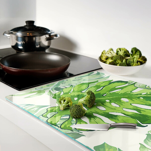 Tabla de cocina Hojas de monstera sobre un fondo claro