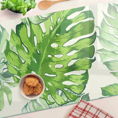 Tabla de cocina Hojas de monstera sobre un fondo claro