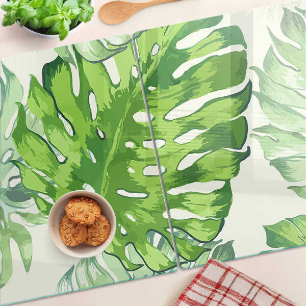 Tabla de cocina Hojas de monstera sobre un fondo claro