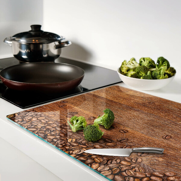 Tabla de cocina Granos de café sobre un fondo de madera