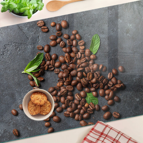 Tabla de cortar de cristal Granos de café sobre un fondo de piedra