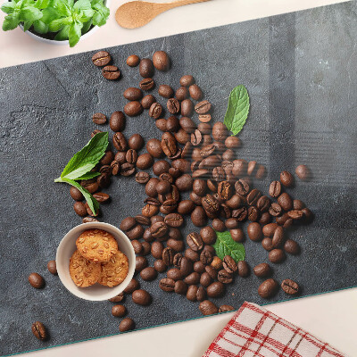 Tabla de cortar de cristal Granos de café sobre un fondo de piedra