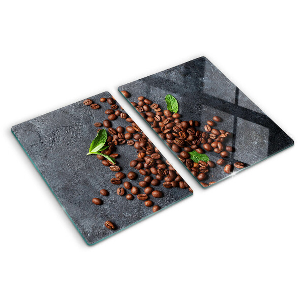 Tabla de cortar de cristal Granos de café sobre un fondo de piedra