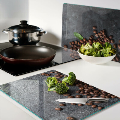 Tabla de cortar de cristal Granos de café sobre un fondo de piedra