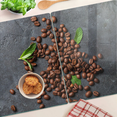 Tabla de cortar de cristal Granos de café sobre un fondo de piedra