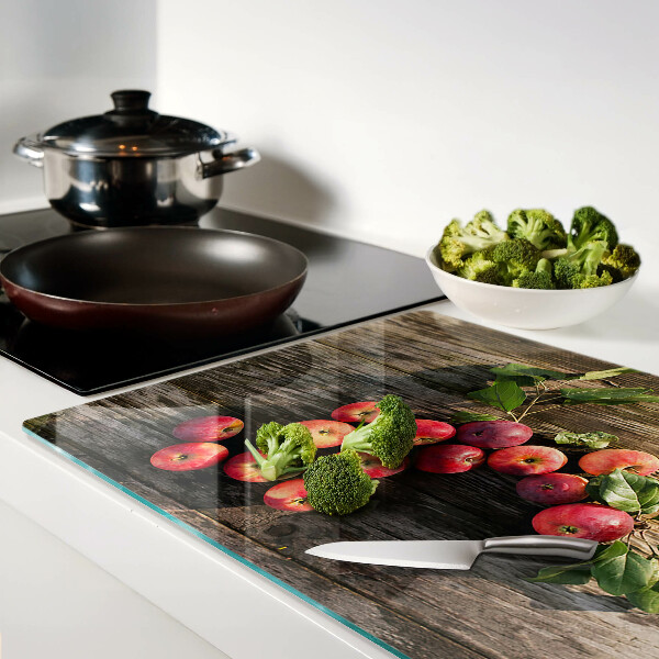 Tabla de cortar de cristal Manzanas sobre un fondo de madera