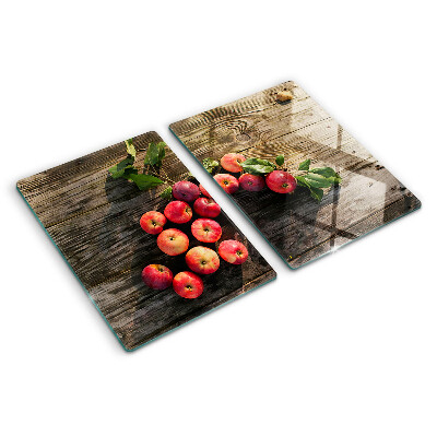Tabla de cortar de cristal Manzanas sobre un fondo de madera