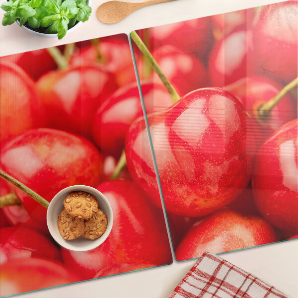 Tabla de cortar de cristal Cerezas sobre fondo rojo