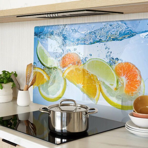 Tabla de cortar de cristal Frutas cítricas en agua